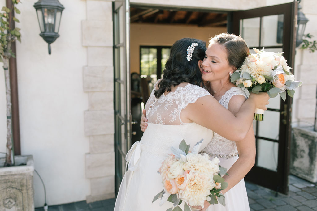 two brides hugging during their first look on their wedding day.