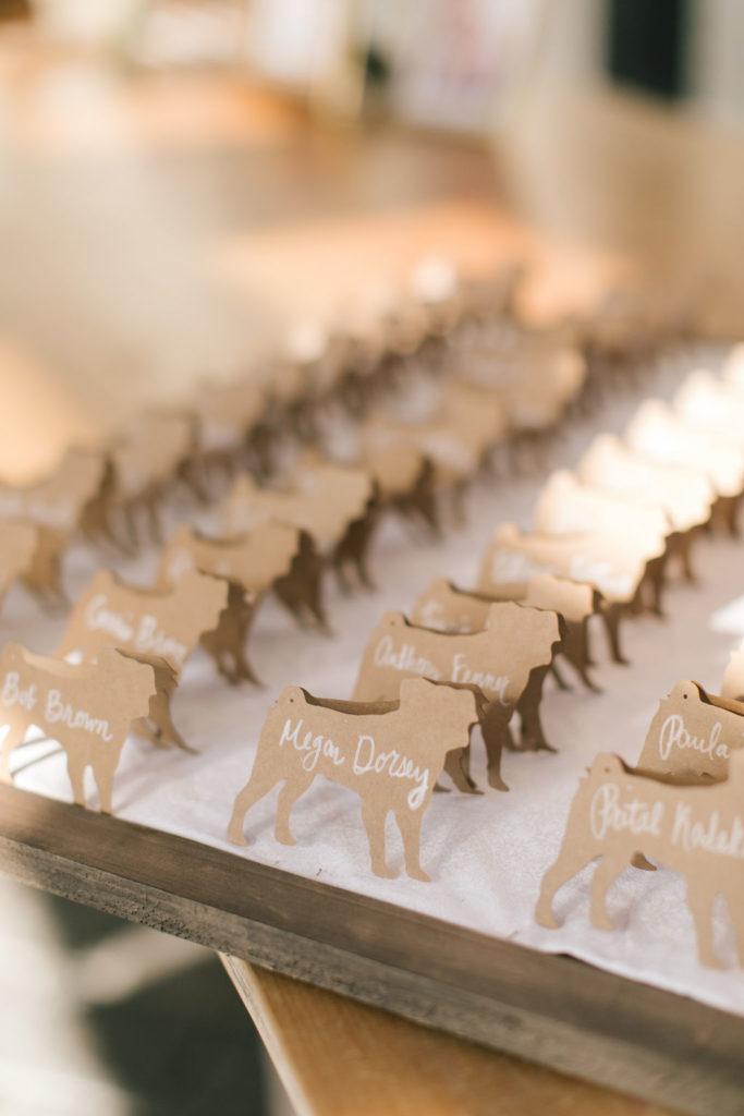 Wedding escort cards in the shape of dogs with handwritten guest names