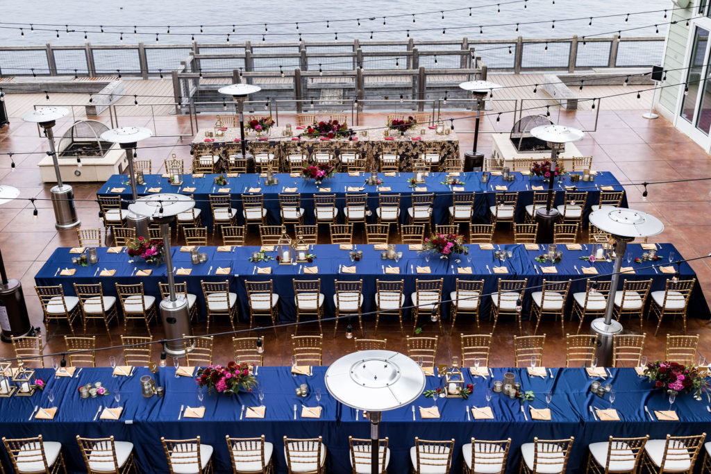 Bright Navy blue and pink wedding reception out doors on the ocean front cannery row in Monterey