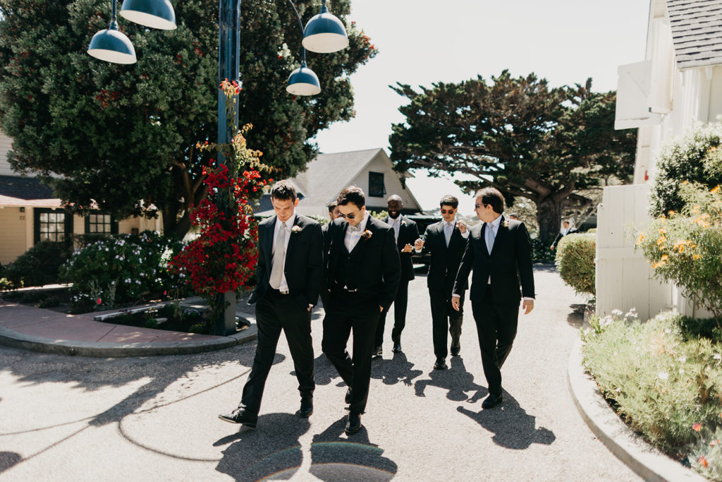 groom and groomsmen walking through Mission Ranch heading toward ceremony