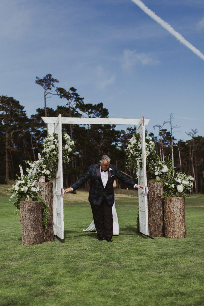 Door and florals marking the entrance to the wedding ceremony