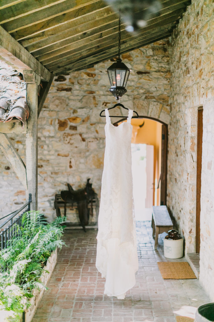 Brides dress hanging in the stone house of Holman Ranch 