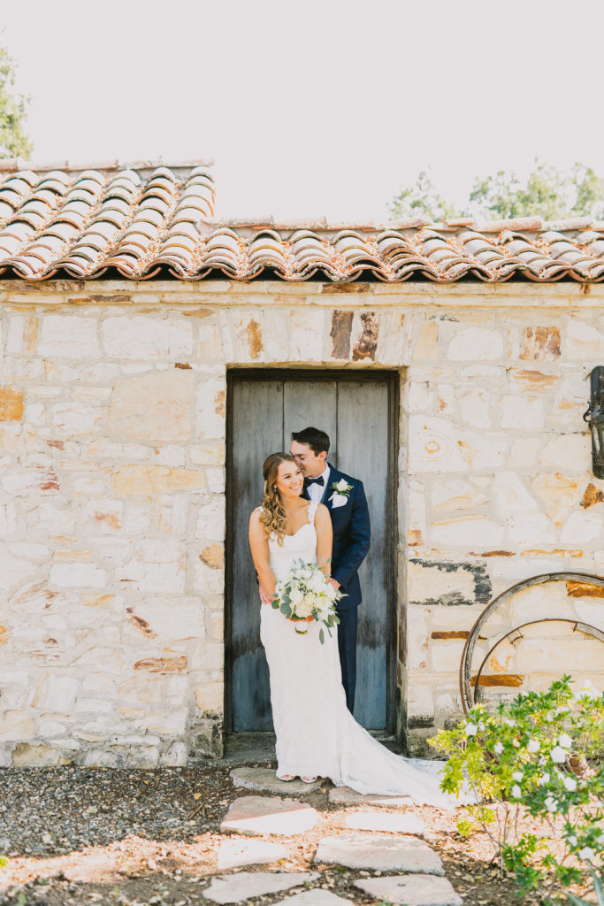 Bride and Groom in front of stone and historical door