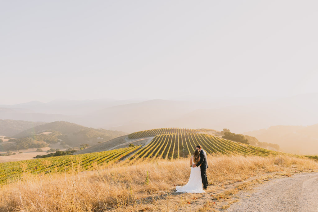couple above the vineyards at golden hour