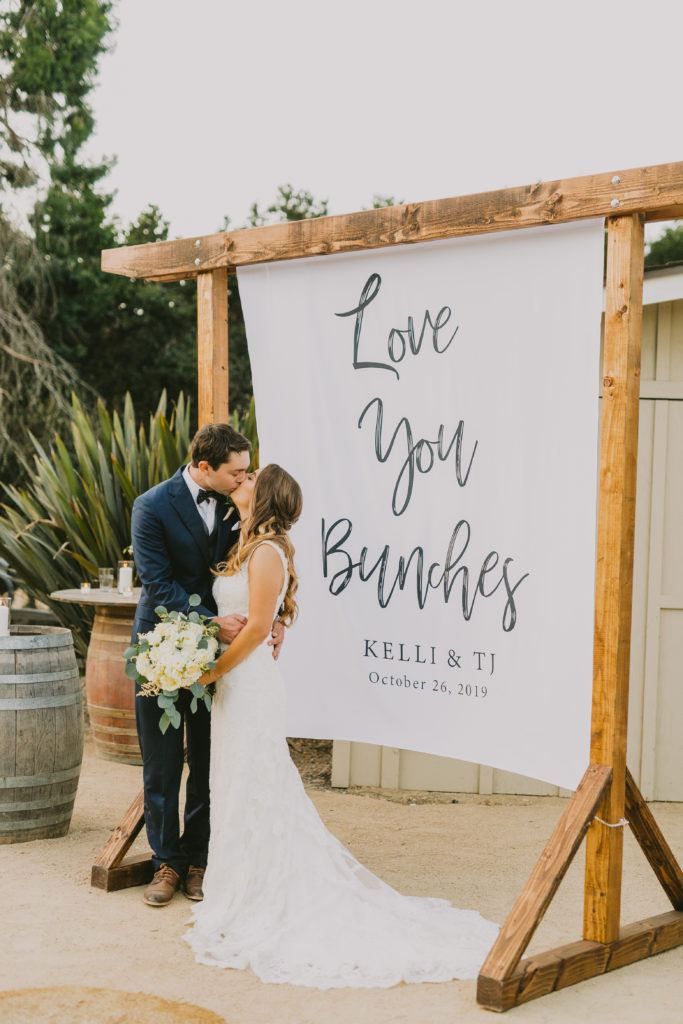 couple in front of a backdrop they created for photos 