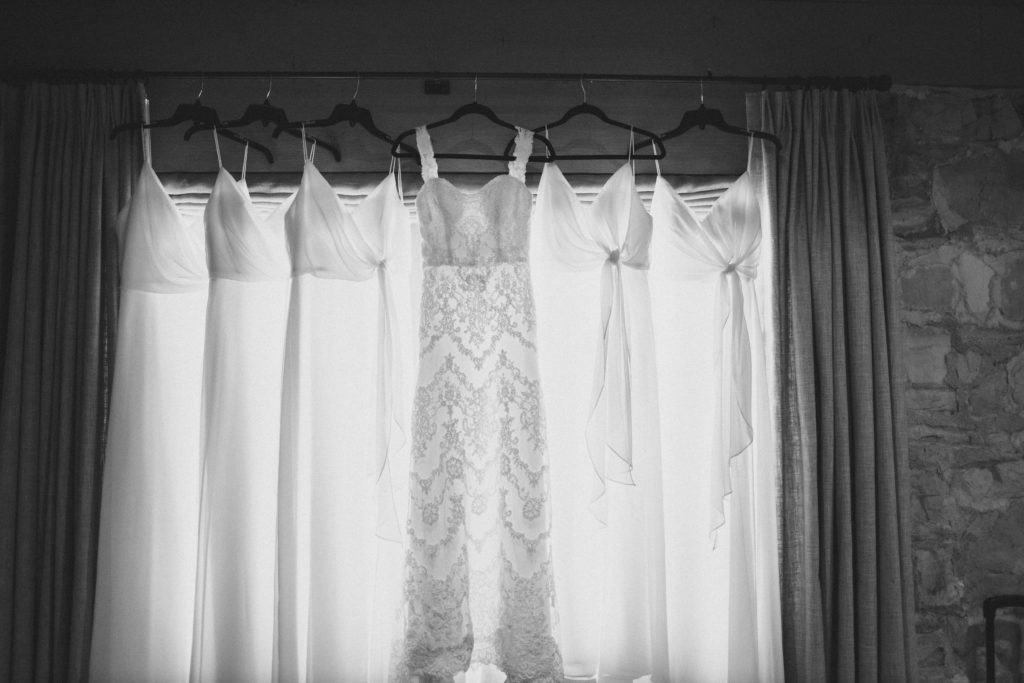 Bridal party dresses hanging in the window of getting ready rooms