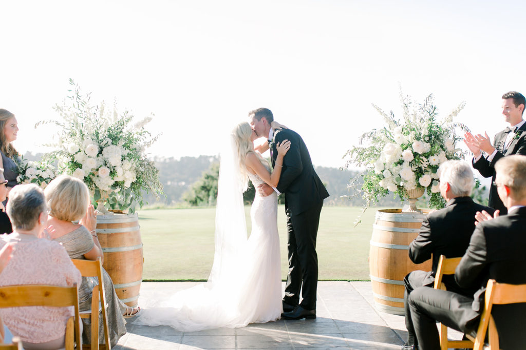 Couple sharing their first kiss at a wedding ceremony at Tehama Golf Course