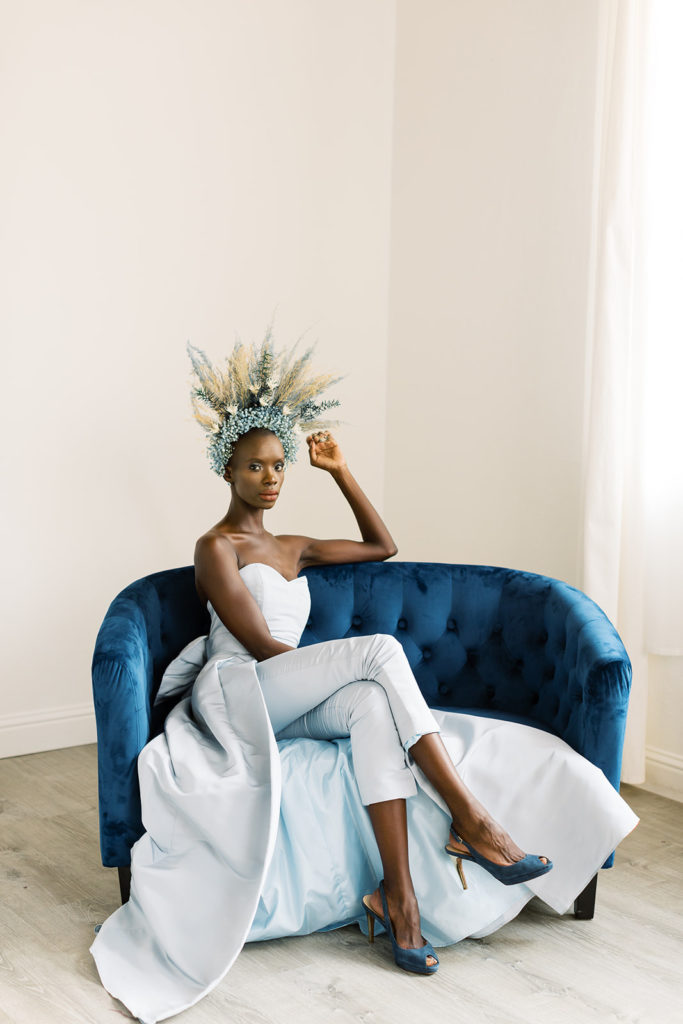 Powerful Bride with blue convertible wedding jumpsuit on vintage furniture