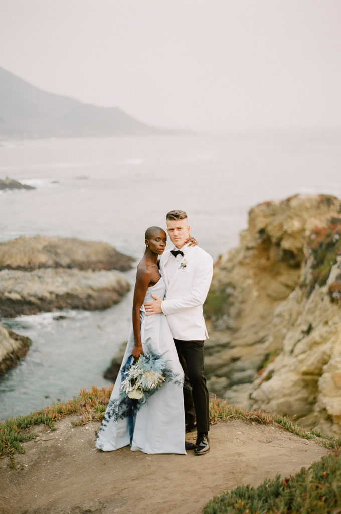 Mixed Race Couple on cliff of Big Sur