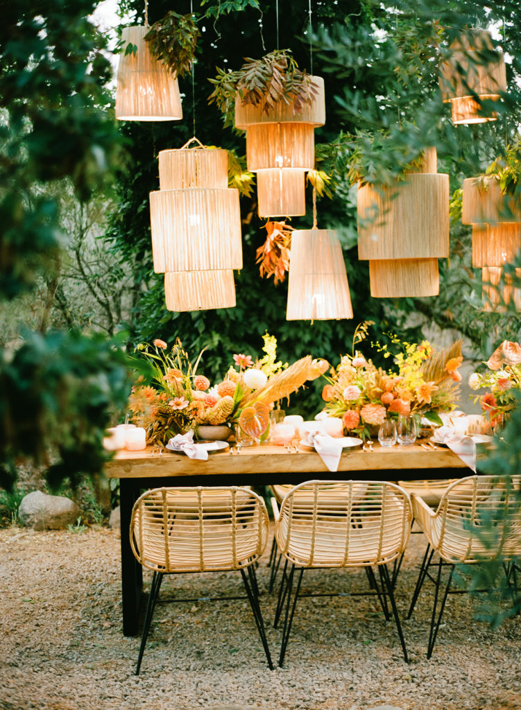 Intimate wedding dinner table with hangin lanterns and modern boho luxury details 
