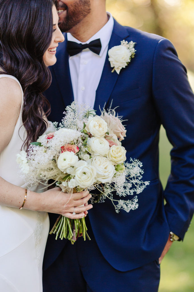 Bride and Groom and bouquet with white blooms