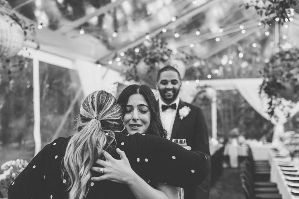 Black and White photo of bride hugging and groom