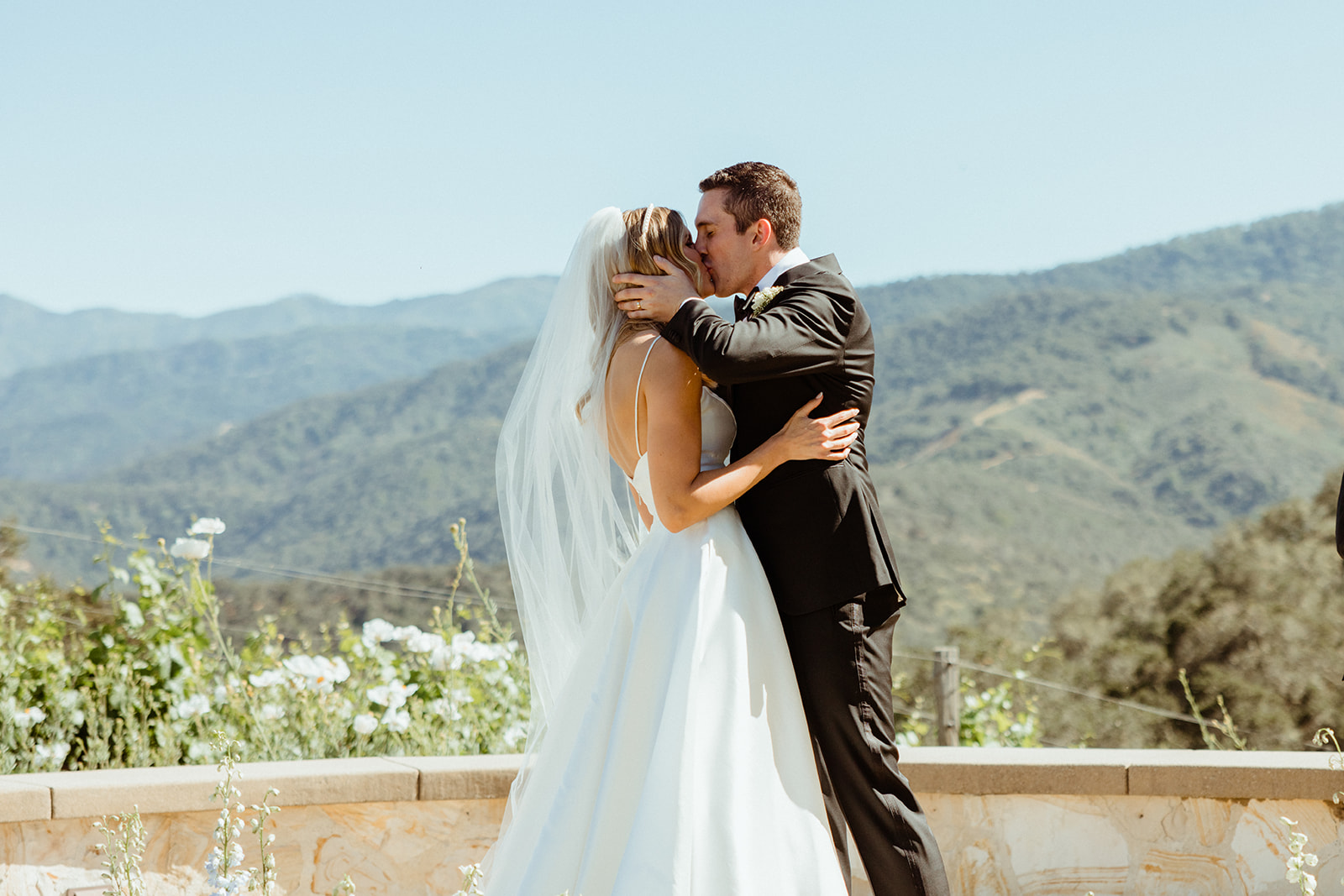 Couple sharing first kiss at Holman Ranch wedding ceremony